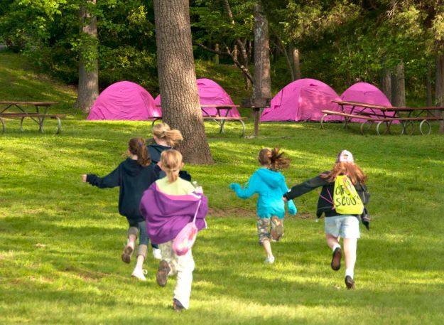 Girl Scouts return to their tents during an overnight at Riverbend.